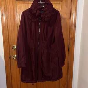 Gorgeous wind resistant coat with beautiful lines and details with a hidden hood